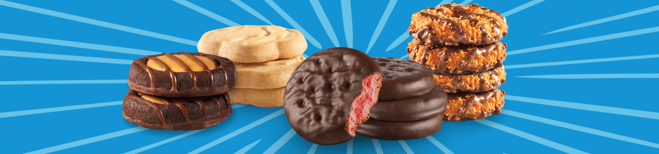 Girl Scouts holding cookie boxes